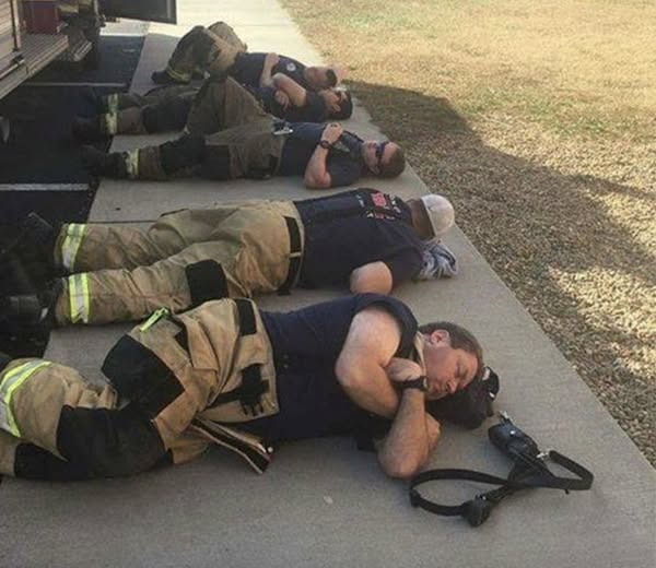 Man snaps heartbreaking photo of firefighters taking a rest after 24 hours of working nonstop